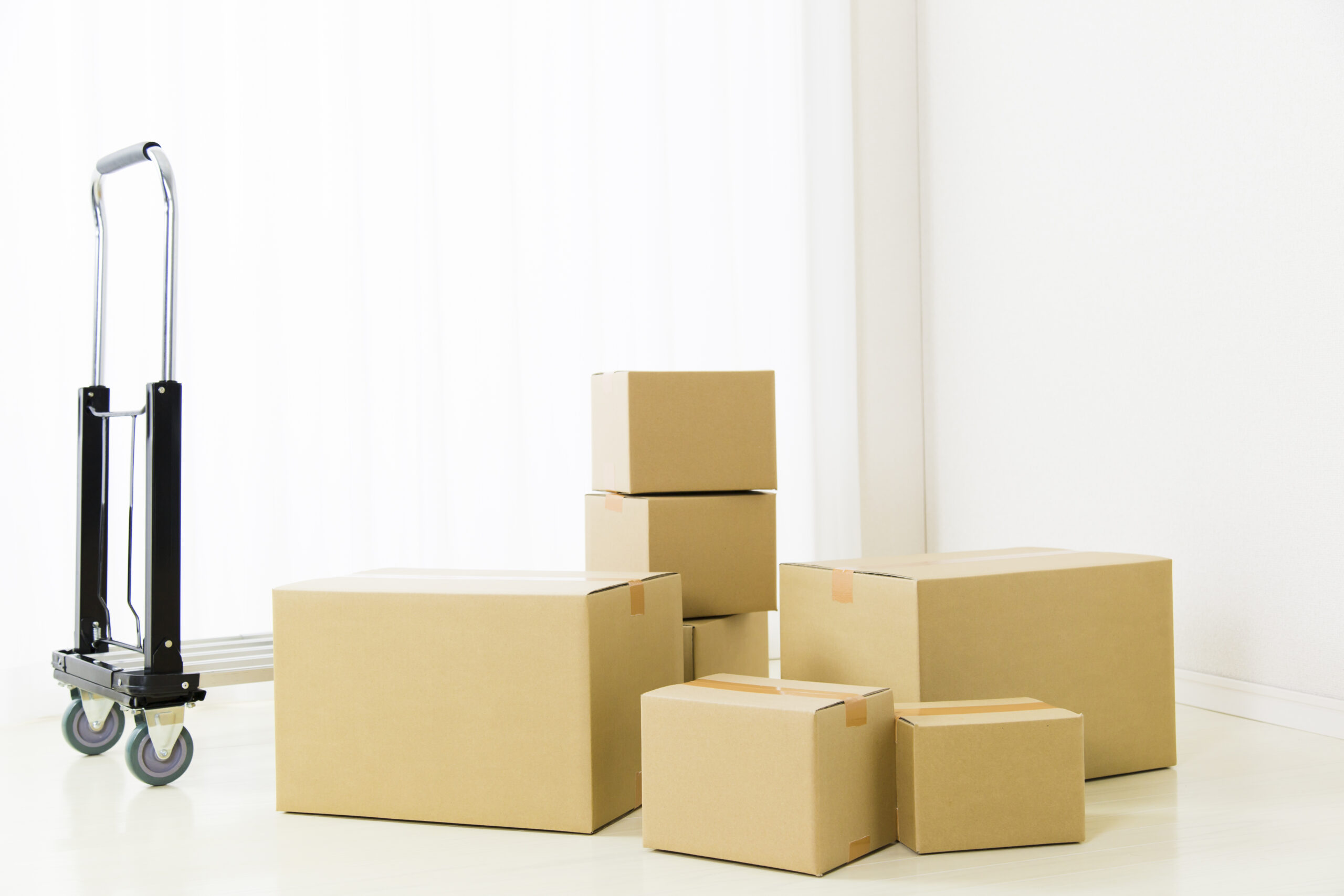 5月の引越しで使われる段ボールと台車のイメージ